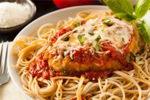 Baked Chicken Parmesan topped with marinara sauce and melted mozzarella cheese.