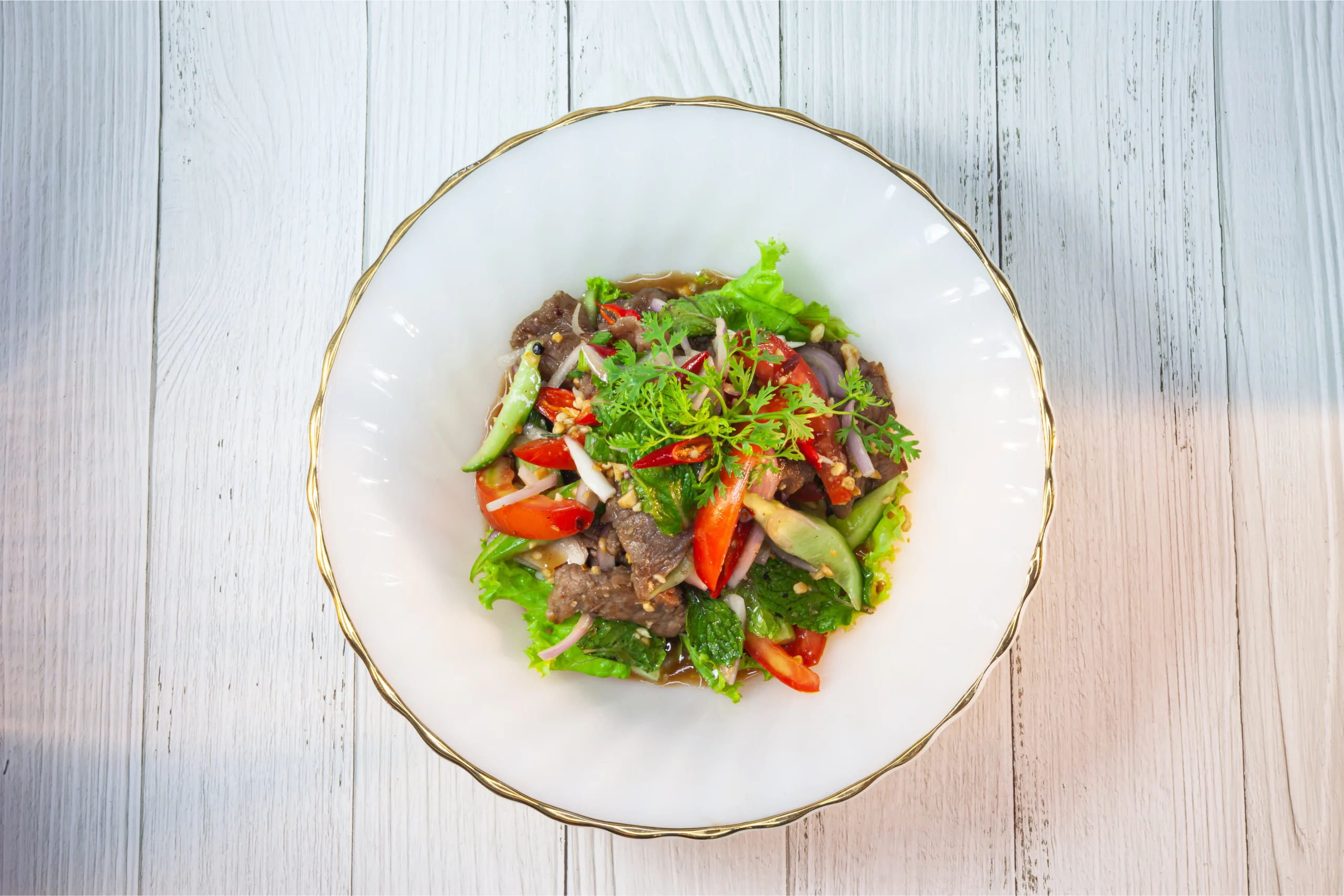 Thai beef salad with grilled beef, fresh herbs, and spicy Thai dressing.